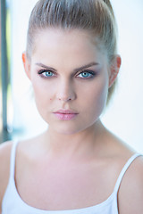 Image showing Blue eyed young woman staring intently