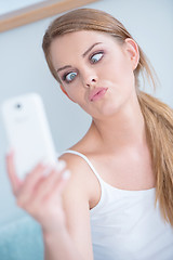 Image showing Young woman pulling a face for selfie