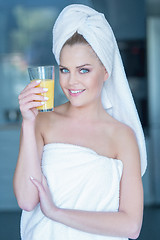 Image showing Lady in towel holding glass of juice
