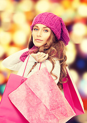 Image showing woman in winter clothes with pink shopping bags
