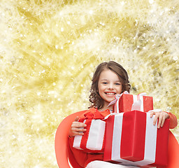 Image showing smiling little girl with gift boxes