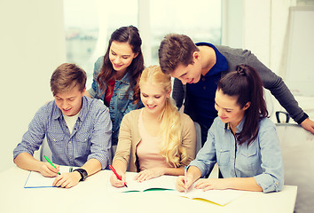 Image showing smiling students with notebooks at school