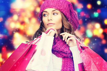 Image showing woman in winter clothes with pink shopping bags