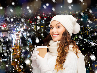 Image showing smiling young woman in winter clothes with cup