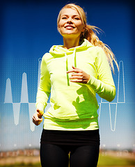 Image showing smiling woman jogging outdoors