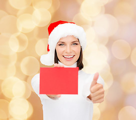 Image showing woman in santa helper hat with blank red card