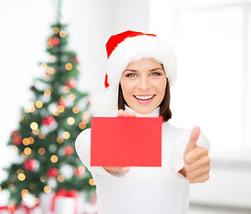 Image showing woman in santa helper hat with blank red card