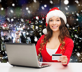 Image showing smiling woman with credit card and laptop