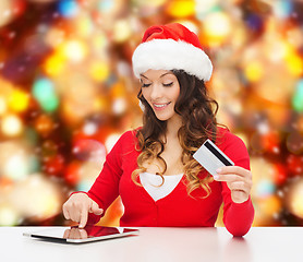 Image showing smiling woman with credit card and tablet pc