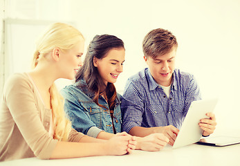 Image showing smiling students with tablet pc computer at school