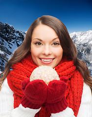 Image showing smiling woman in winter clothes with snowball