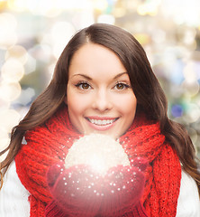 Image showing smiling woman in winter clothes with snowball