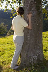 Image showing Woman holding a tree