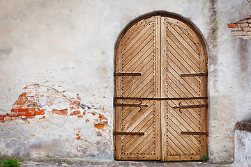 Image showing Wooden door in an old style. Courtyard of old castle