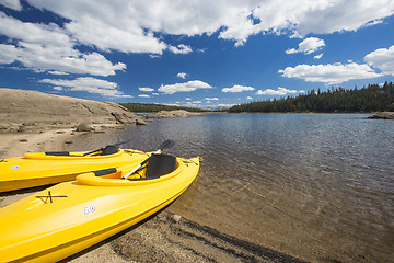 Image showing Pair of Yellow Kayaks on Beautiful Mountain Lake Shore.