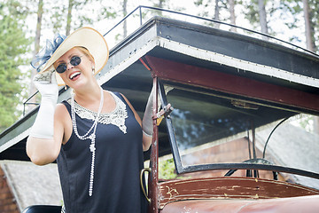 Image showing Attractive Woman in Twenties Outfit Near Antique Automobile