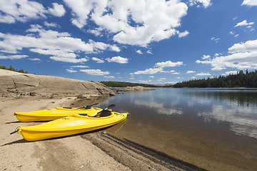 Image showing Pair of Yellow Kayaks on Beautiful Mountain Lake Shore.