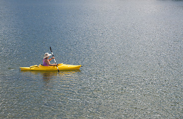 Image showing Woman Kayaking on Beautiful Mountain Lake.