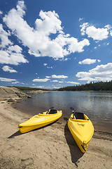 Image showing Pair of Yellow Kayaks on Beautiful Mountain Lake Shore.