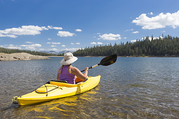 Image showing Woman Kayaking on Beautiful Mountain Lake.