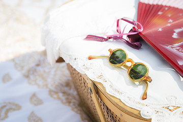 Image showing Sunglasses, Chinese Fan and Picnic Basket on Blanket