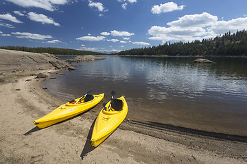 Image showing Pair of Yellow Kayaks on Beautiful Mountain Lake Shore.