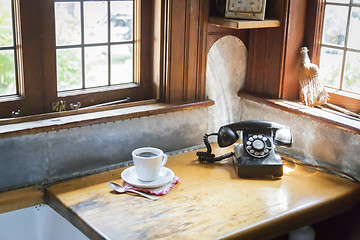 Image showing Antique Phone and Cup of Coffee in Old Kitchen Setting