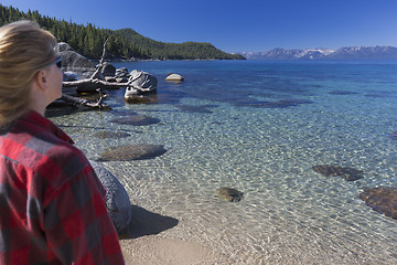 Image showing Woman Looking Over Beautiful Shoreline of Lake Tahoe.