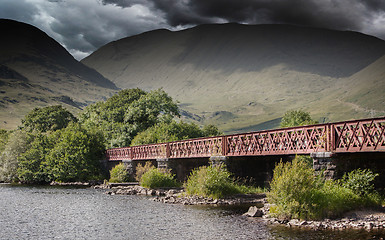 Image showing Structure of metal railway bridge, stormy clouds