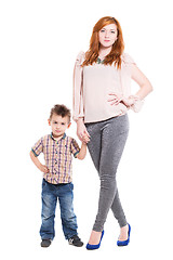 Image showing Young redhead woman posing with her little son