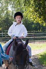 Image showing little girl riding horse