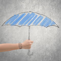 Image showing concept of waterproof by holding a umbrella