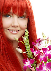 Image showing lovely redhead with orchid