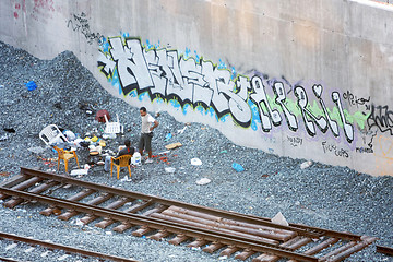 Image showing Two men hanging out next to railway