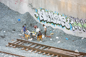 Image showing Small group of men next to railway