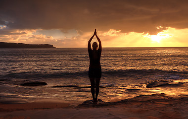 Image showing Woman Tadasana  -  Mountain Pose  yoga by the sea at sunrise