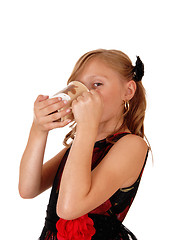 Image showing Girl drinking from a mug.