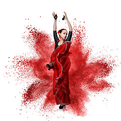 Image showing young woman dancing flamenco against explosion