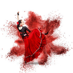 Image showing young woman dancing flamenco against explosion