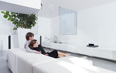 Image showing young couple on sofa watching TV