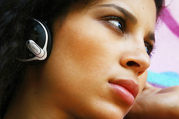 Image showing face of girl listening to MP3 player