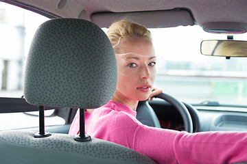 Image showing Lady looking back while reversing.