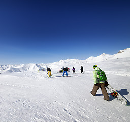 Image showing Skiers and snowboarders on ski slope