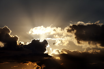 Image showing Sunset sky with dark clouds and sun rays