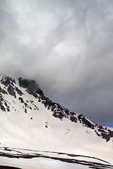 Image showing Snowy mountains in storm clouds