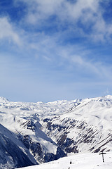 Image showing Snowy mountains and ski slope at nice day