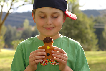 Image showing Child holding a donut