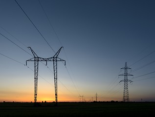 Image showing Large transmission towers at sunset