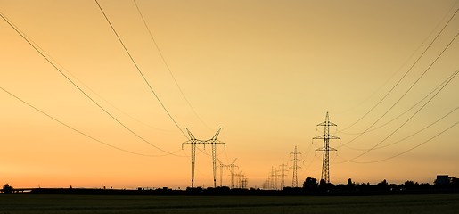 Image showing Large transmission towers at sunset