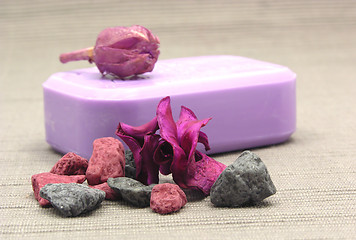 Image showing Lilac soap with decoration articles on a  gray  background